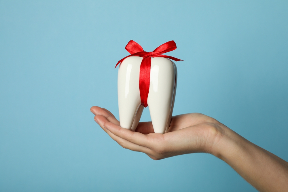 wrapped tooth, to show Citrus Smiles Dental Studio's commitment to gifting better smiles through cosmetic dentistry treatments