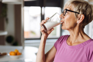 older woman drinking milk