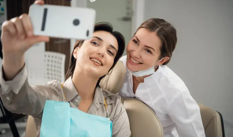 dentist and patient posing for selfie