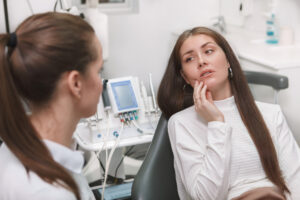 woman with pain at dentist