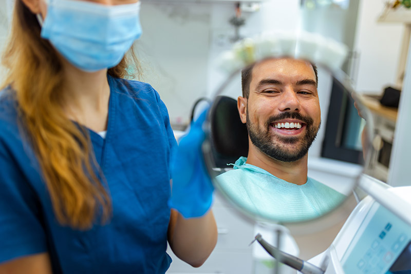 patient looking at his new smile at the dentist