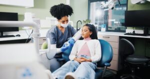 dentist educating young patient